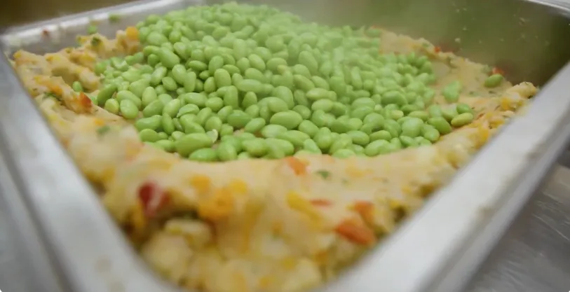 Cooked soybeans used as a food ingredient in a metal tray.